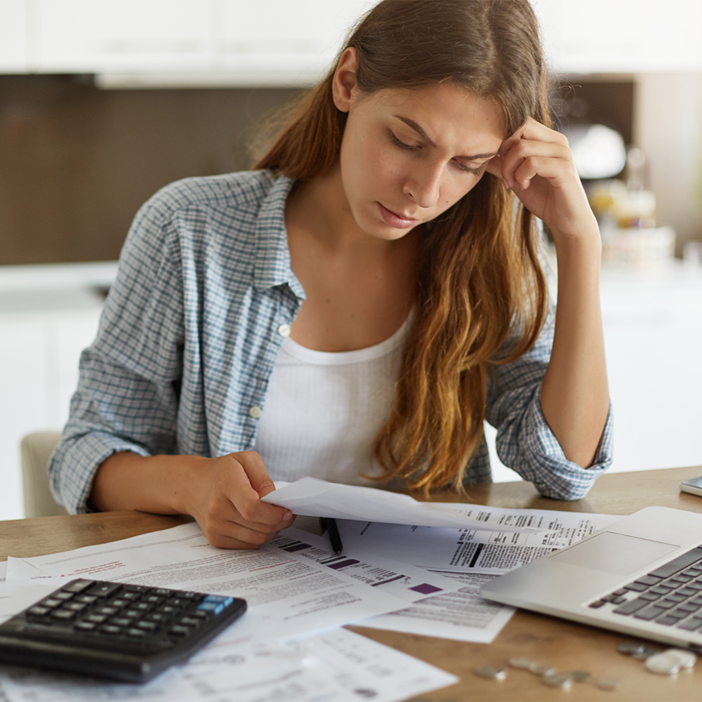woman looking stressed over bills