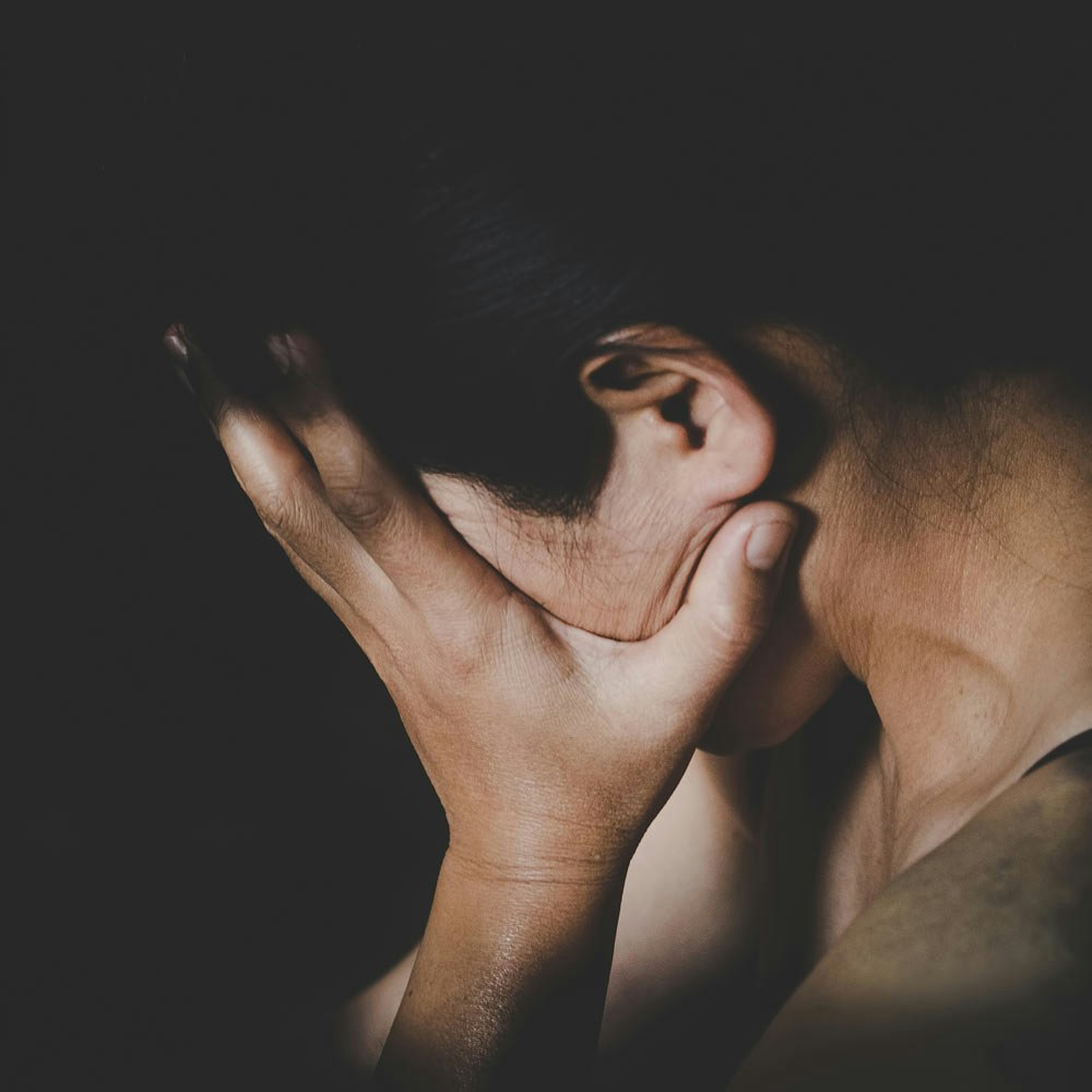 woman shielding face