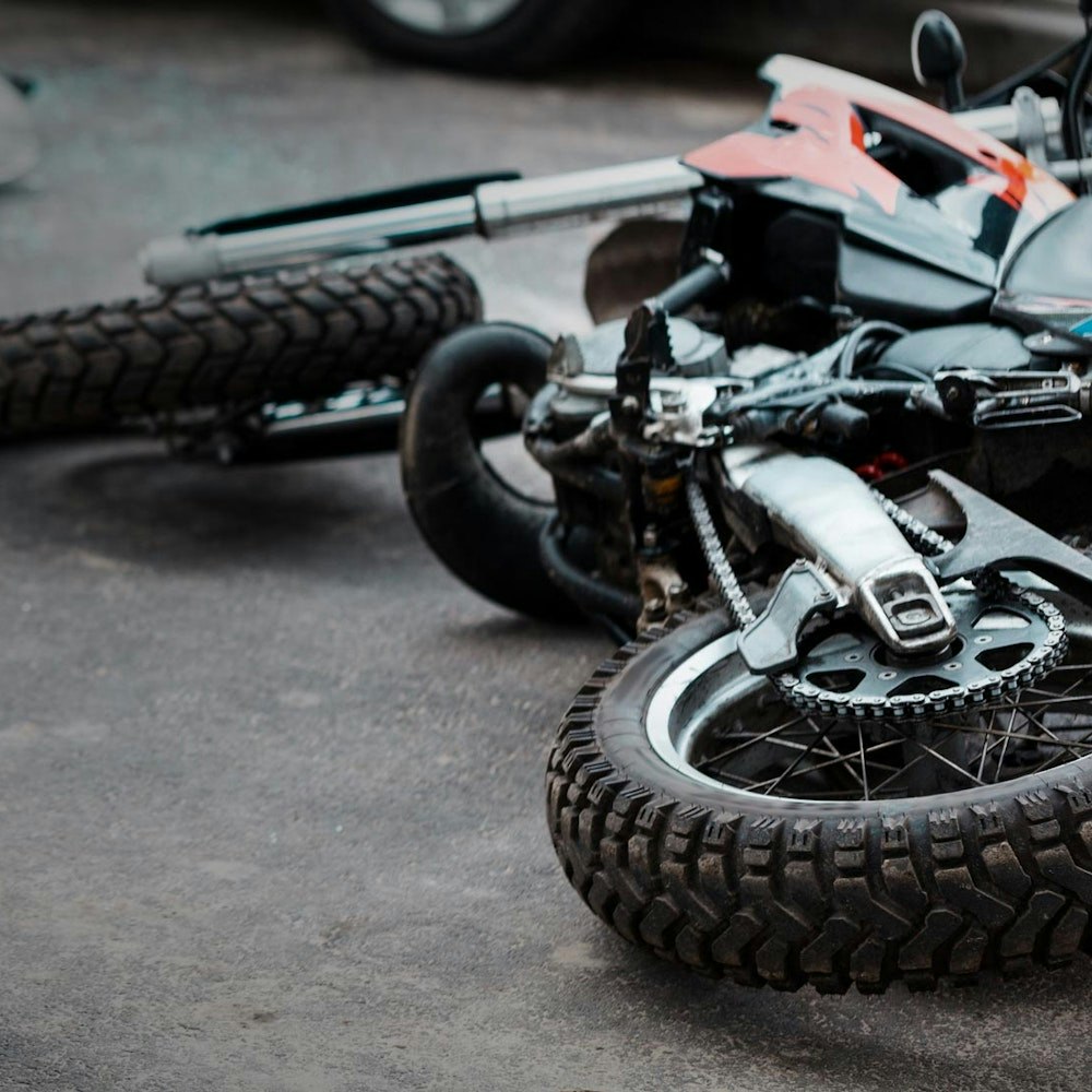 Crashed motorcycle, with helmet nearby
