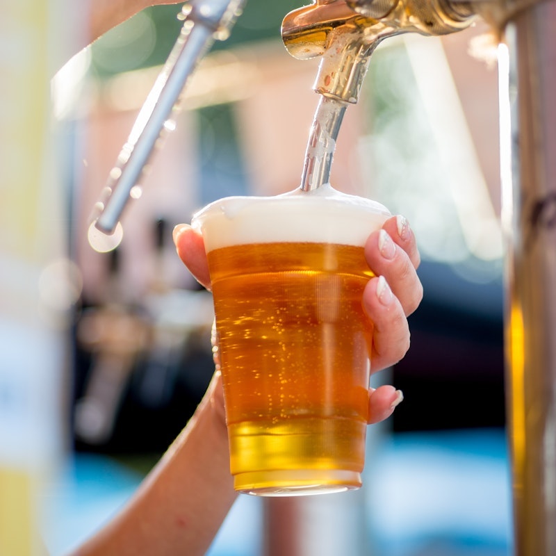 Person pouring a beer