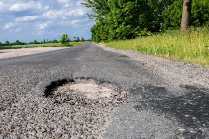 Dangerous road with potholes