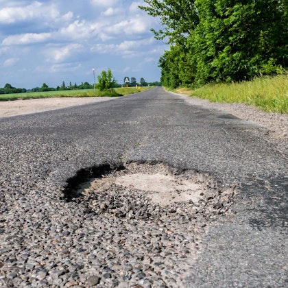 Dangerous road with potholes