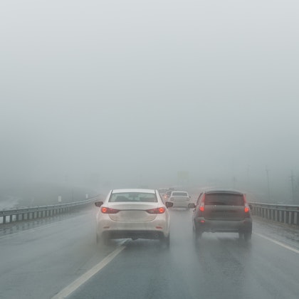 Car driving in the rain with wet roads