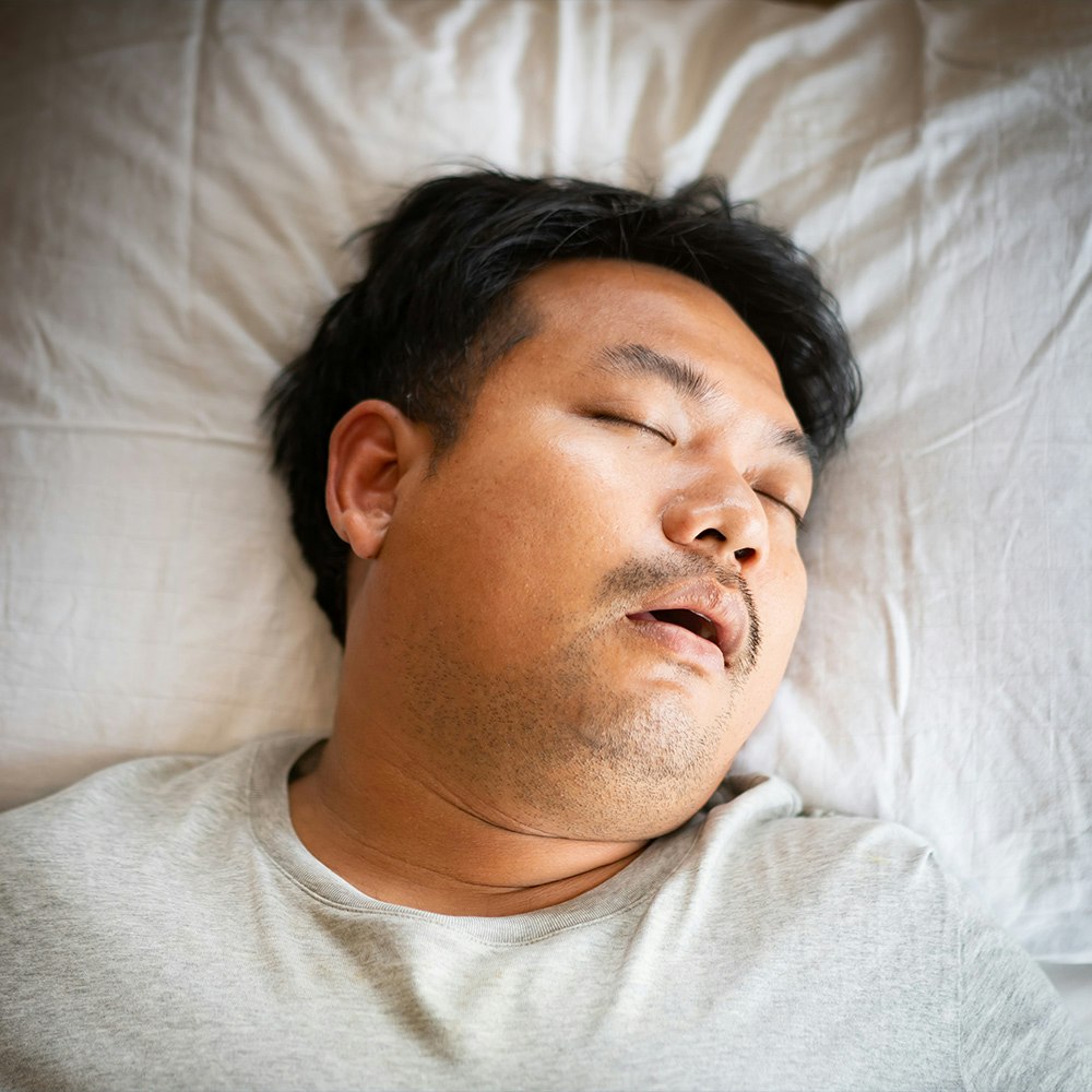Sleeping man snoring from Sleep Apnea
