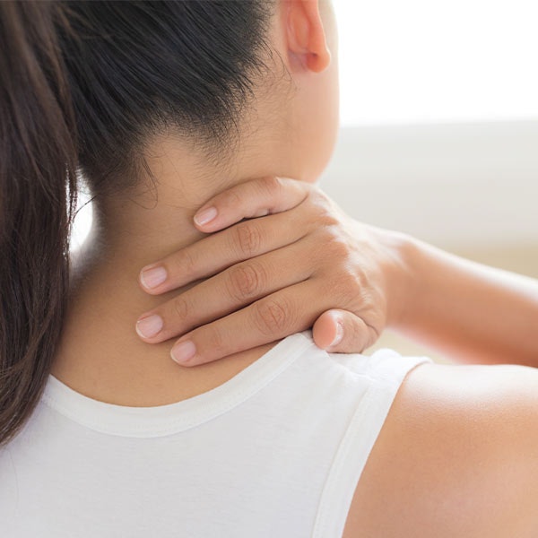 woman holding neck in pain
