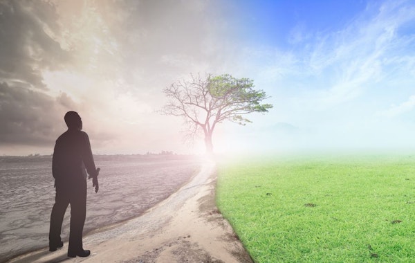 Man standing at beginning of long path