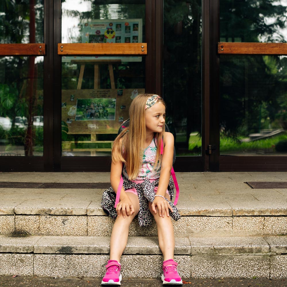 Sitting child looking for parent after school