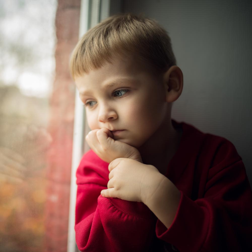 lone child staring out window