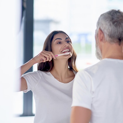 woman brushing her teeth