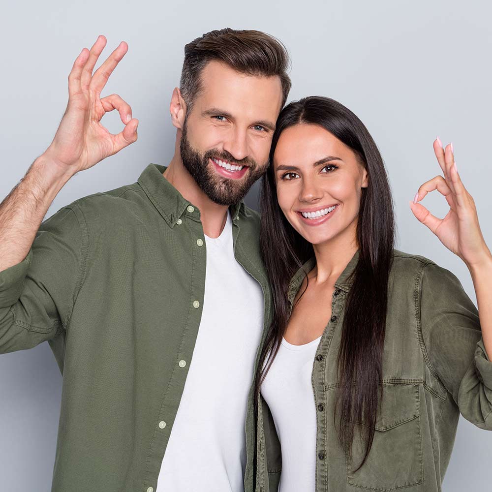 smiling couple in green