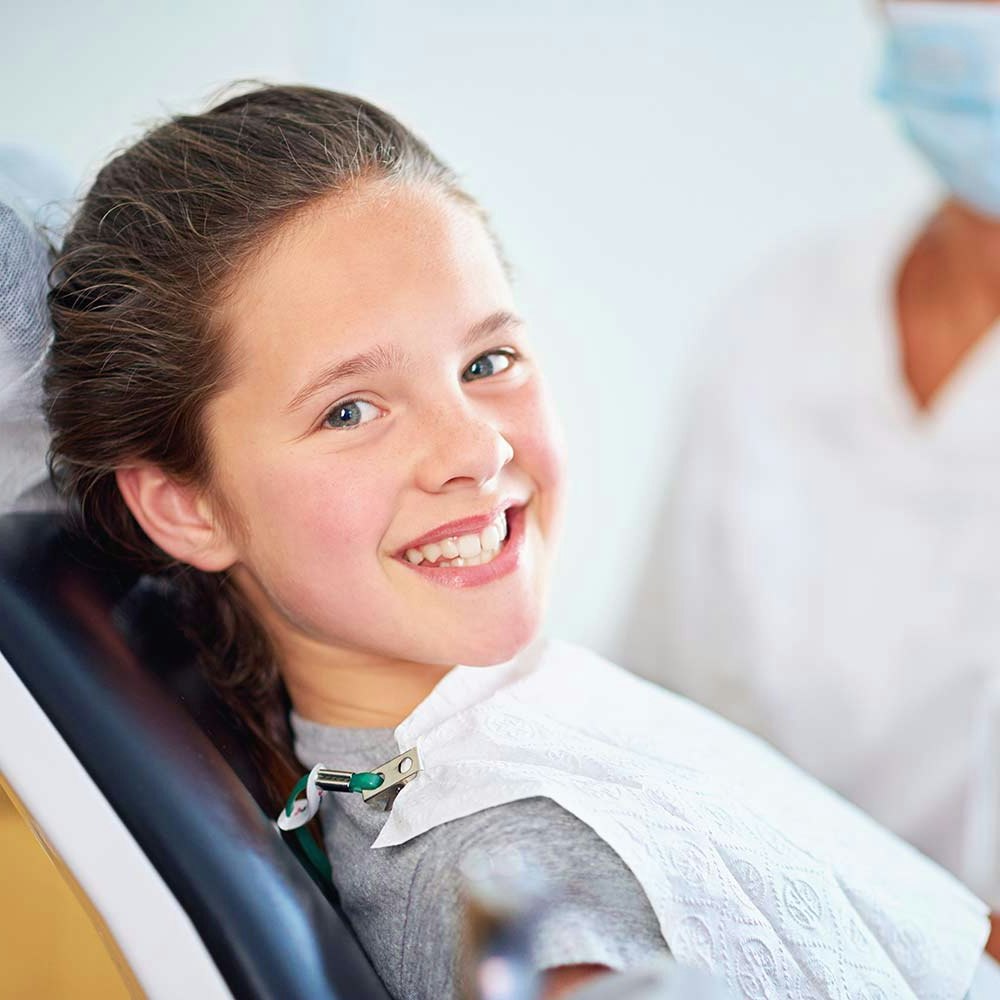 Smiling girl in the exam chair