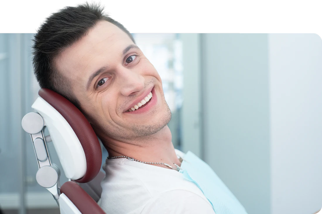 young man in dental chair smiling