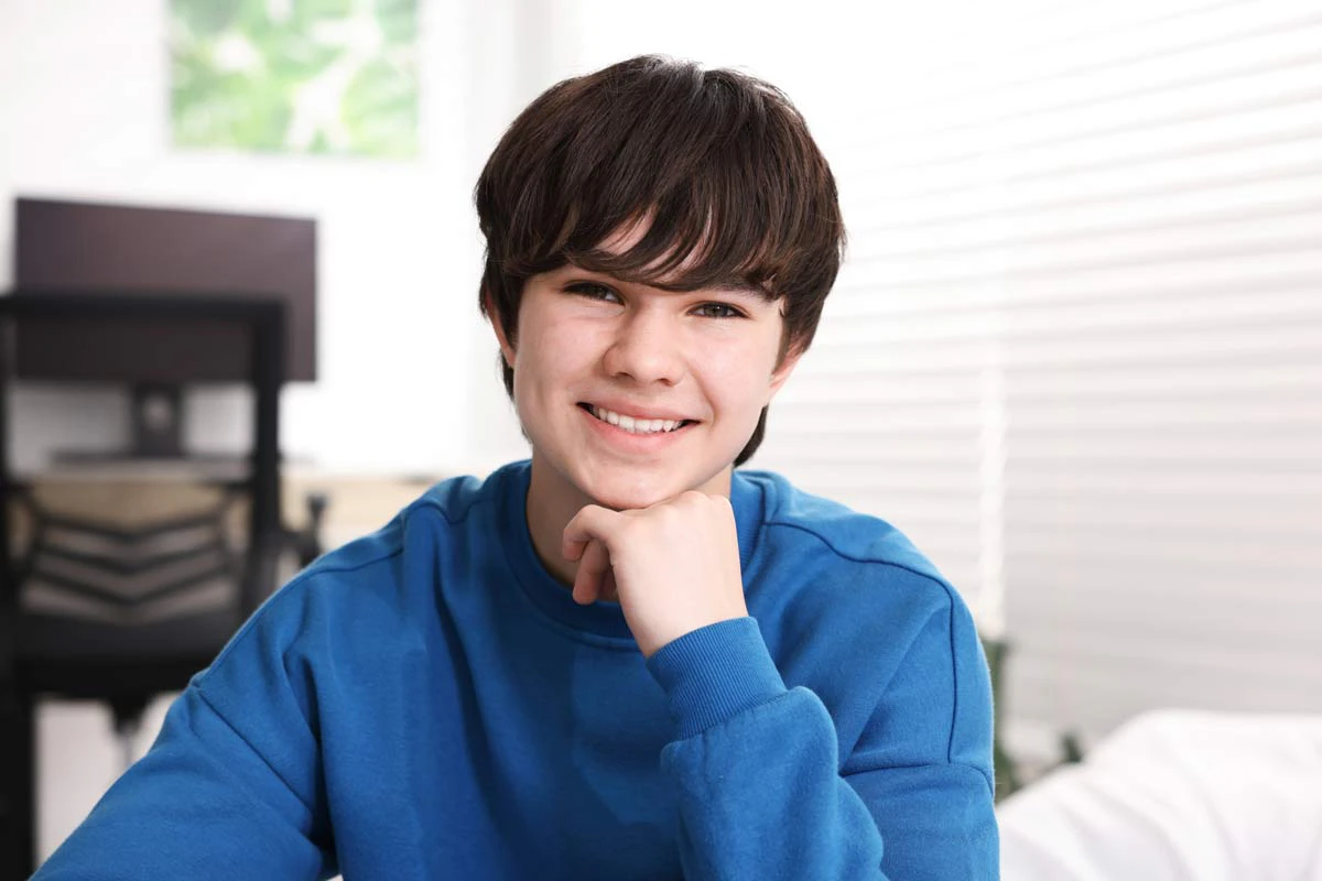 dark haired teenage boy smiling