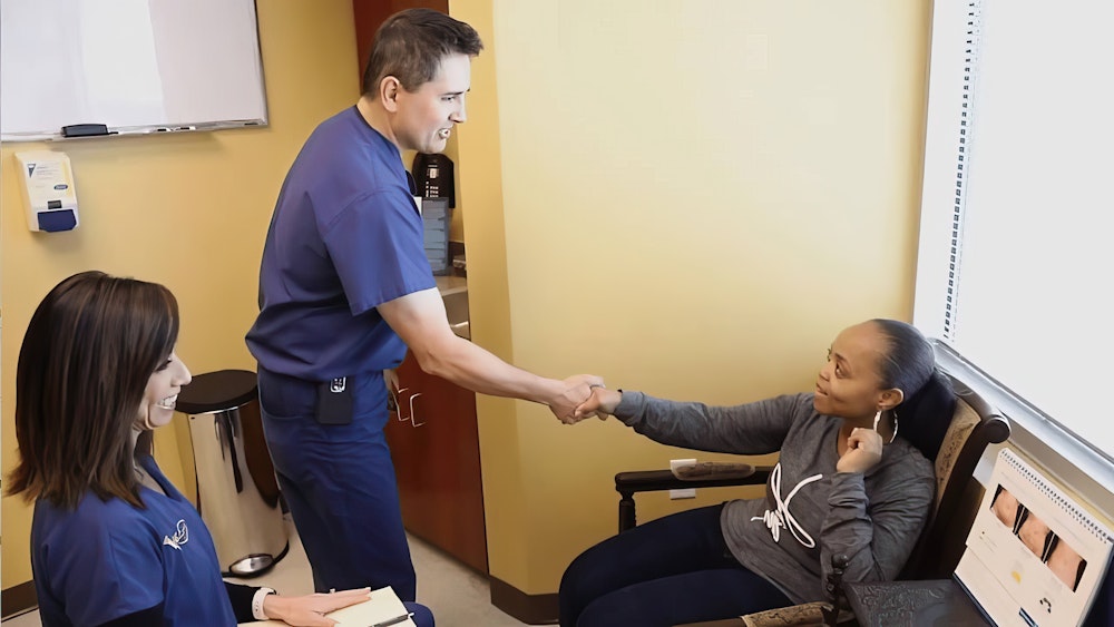 Dr. St. Laurent shaking hands with a patient
