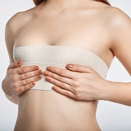 Woman with bandages on breasts