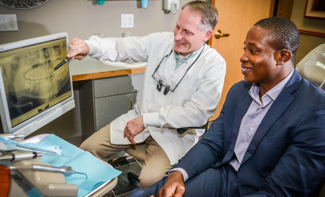 Dr. Fuqua reviewing scans with patient