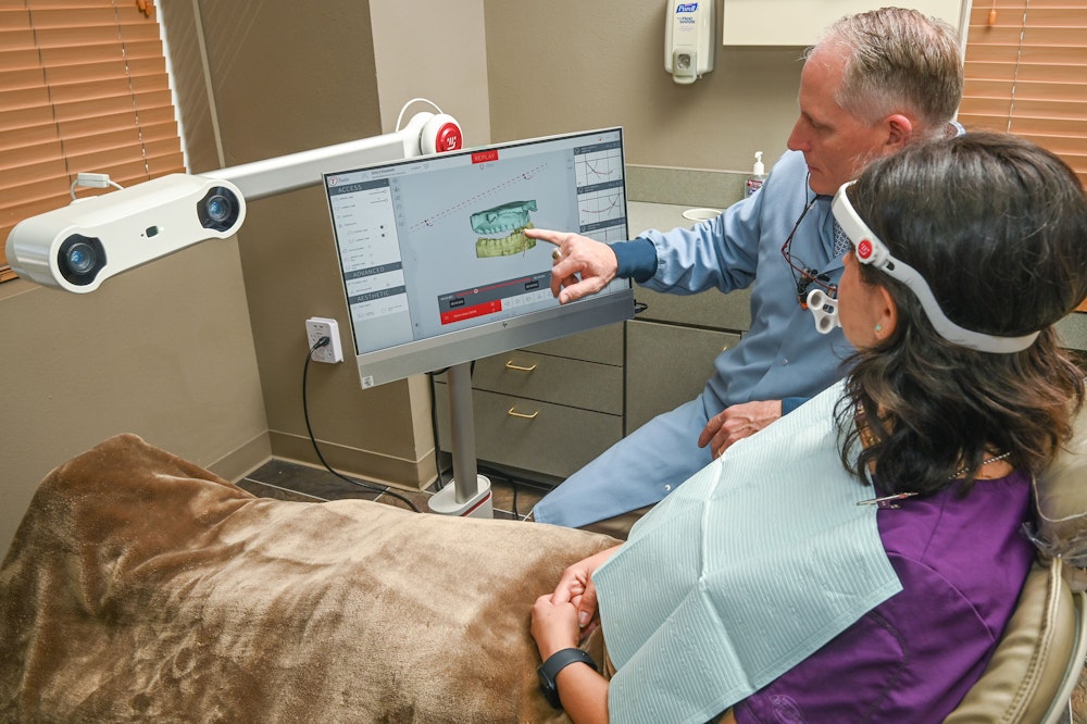 Dr. Fuqua reviewing scans with a patient