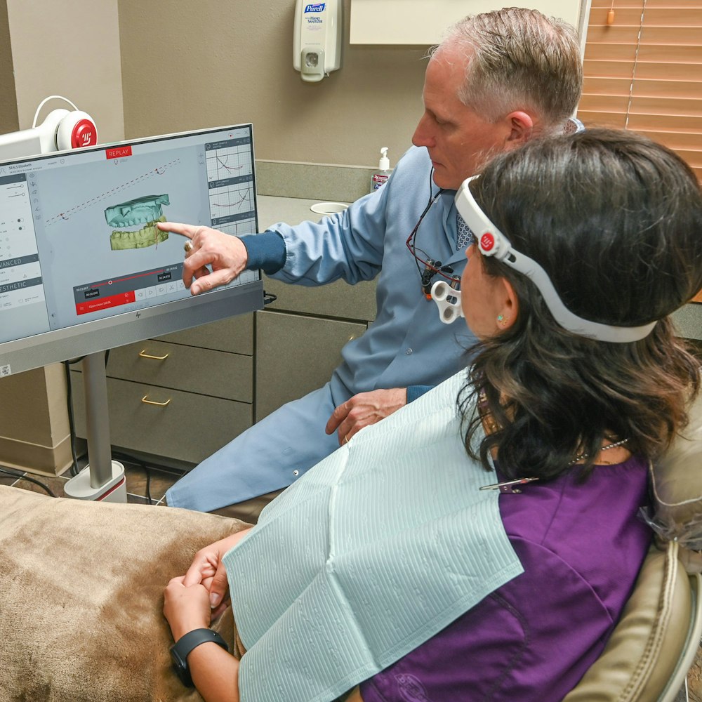 Dr. Fuqua reviewing scans with a patient
