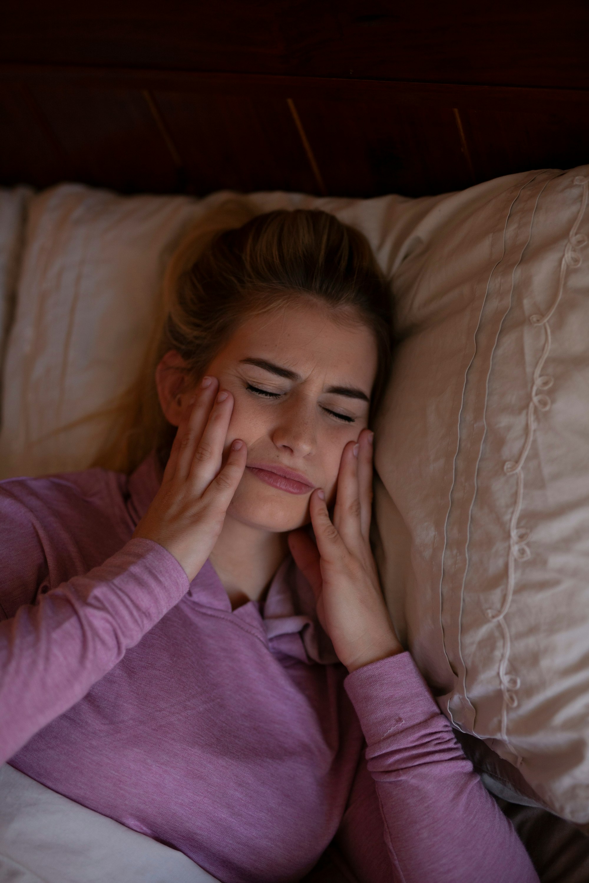 Woman in face pain while sleeping