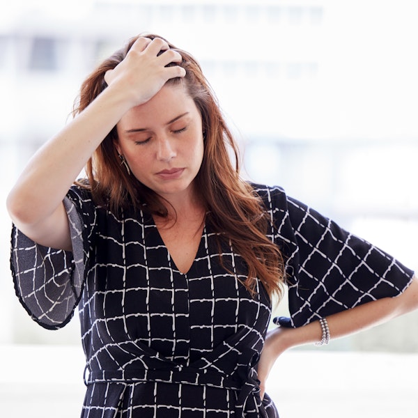 Stressed woman running hand through her hair