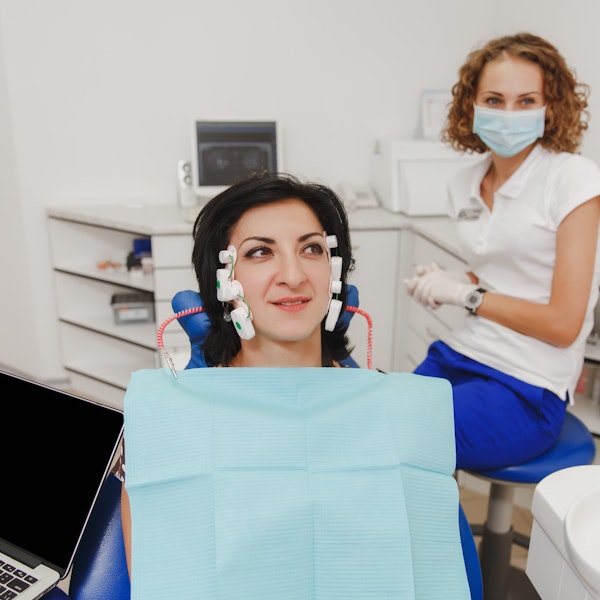 Woman hooked up to neuromuscular machine at the dentist