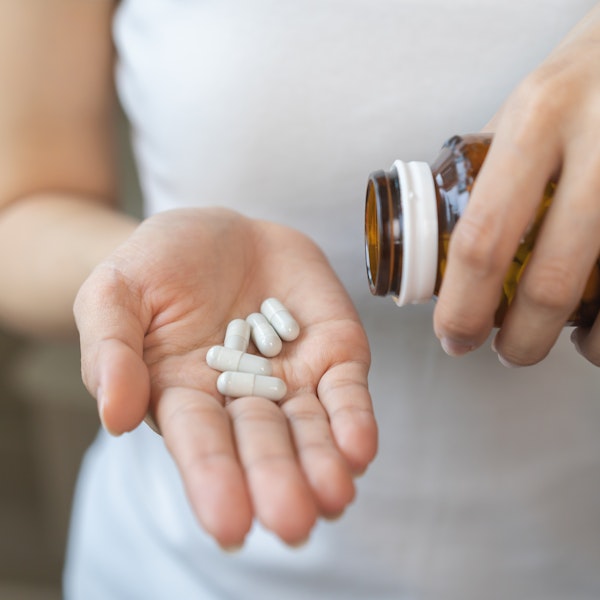 Medication being placed on an outstretched hand