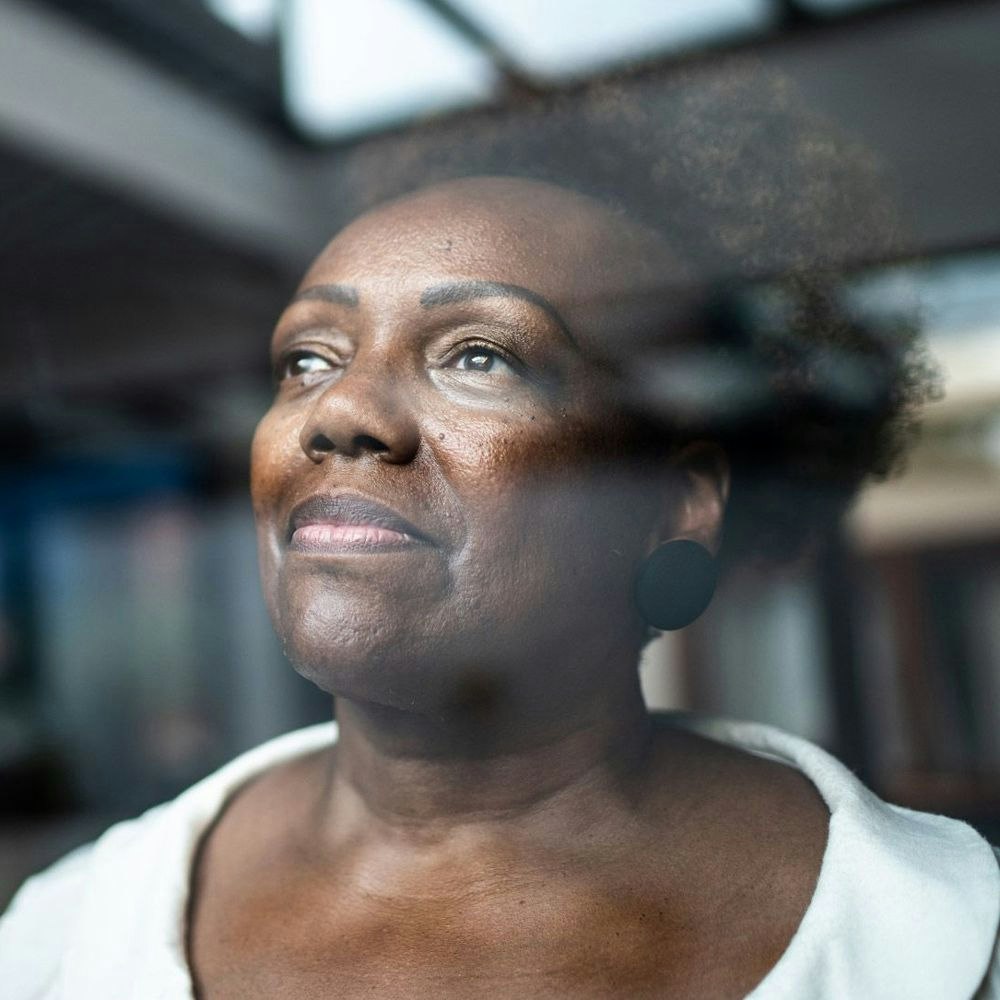 older woman looking out a window