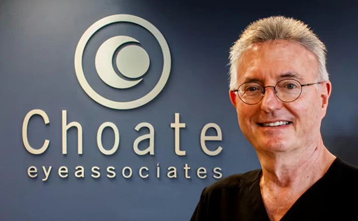 Dr. Walter Choate standing in front of the Choate Eye Associates sign