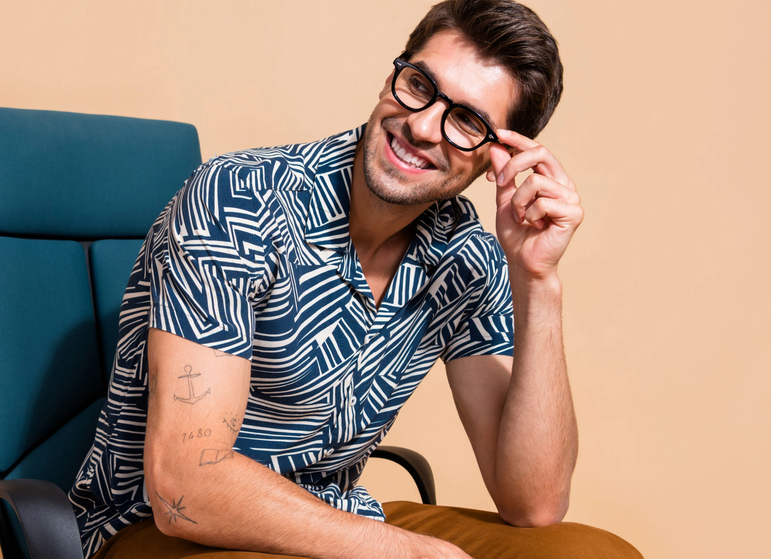 Smiling man adjusting his eyeglasses