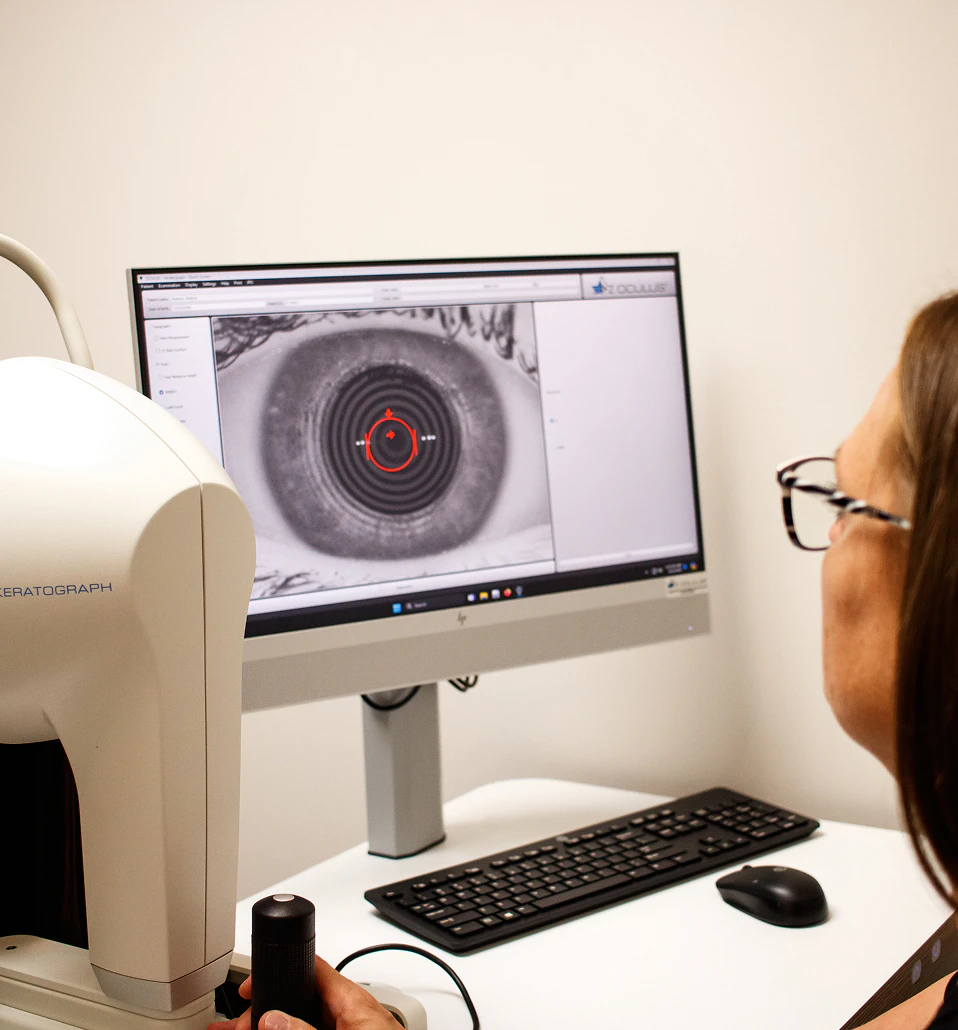 Technician reviewing meibography scan results on a monitor