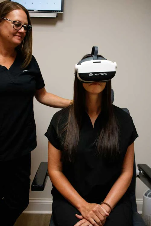 Patient wearing a Neurolens diagnostic headset during testing