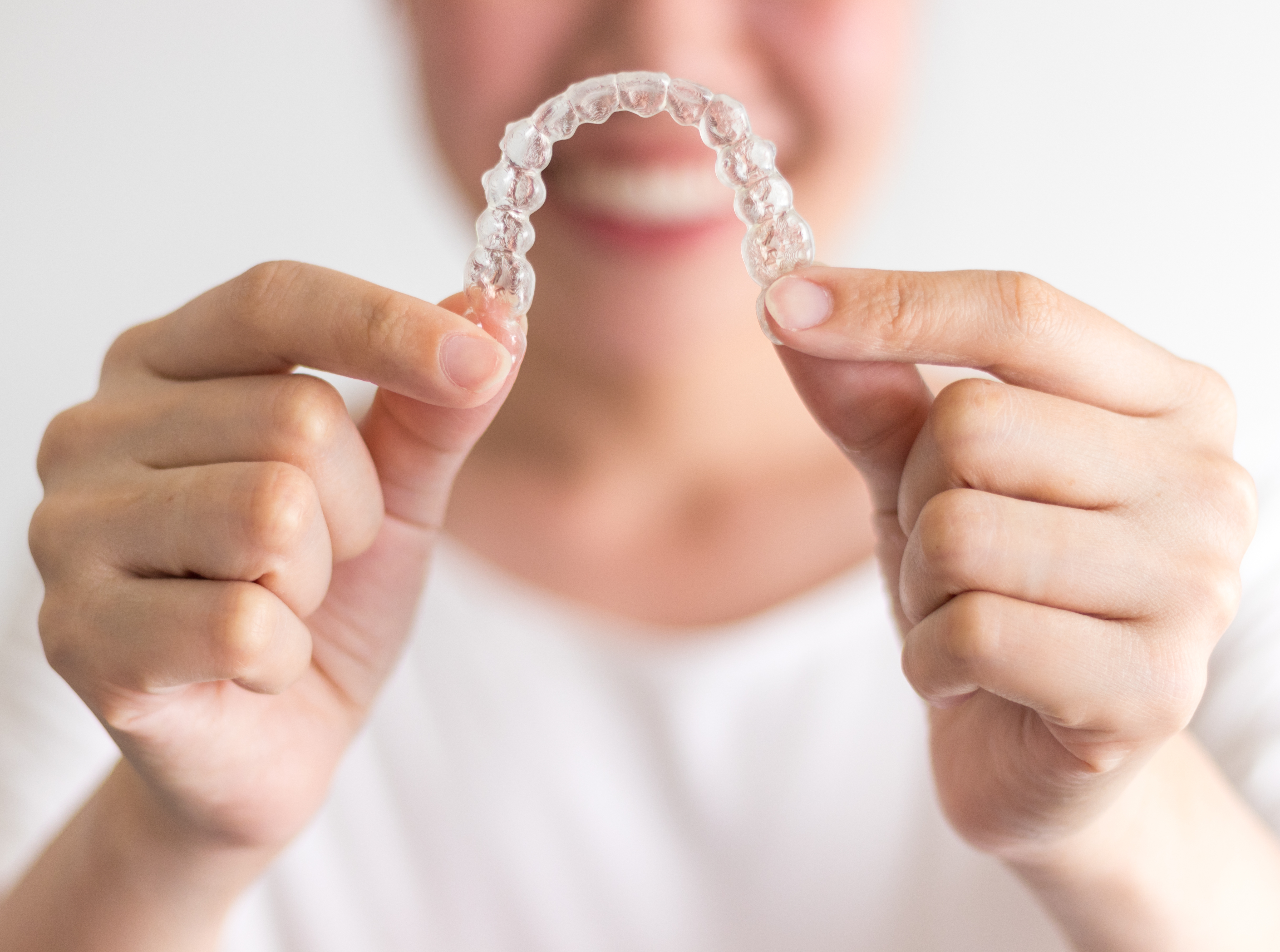 Person holding Invisalign tray