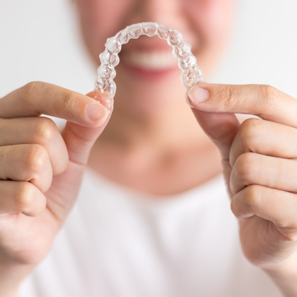 Person holding Invisalign tray