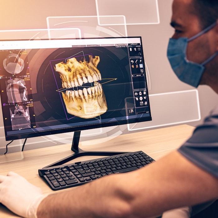 Examining 3D scan of patient's teeth and jaw