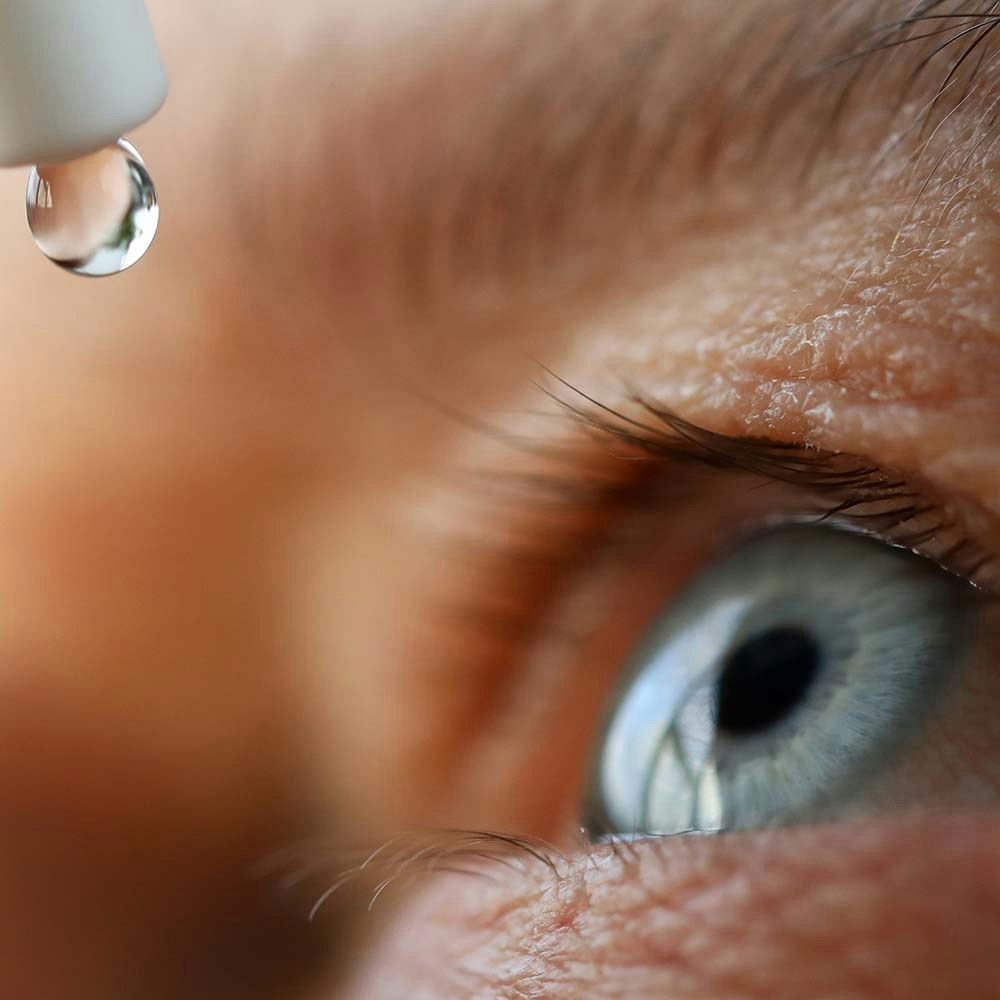 Closeup of someone putting in eye drops