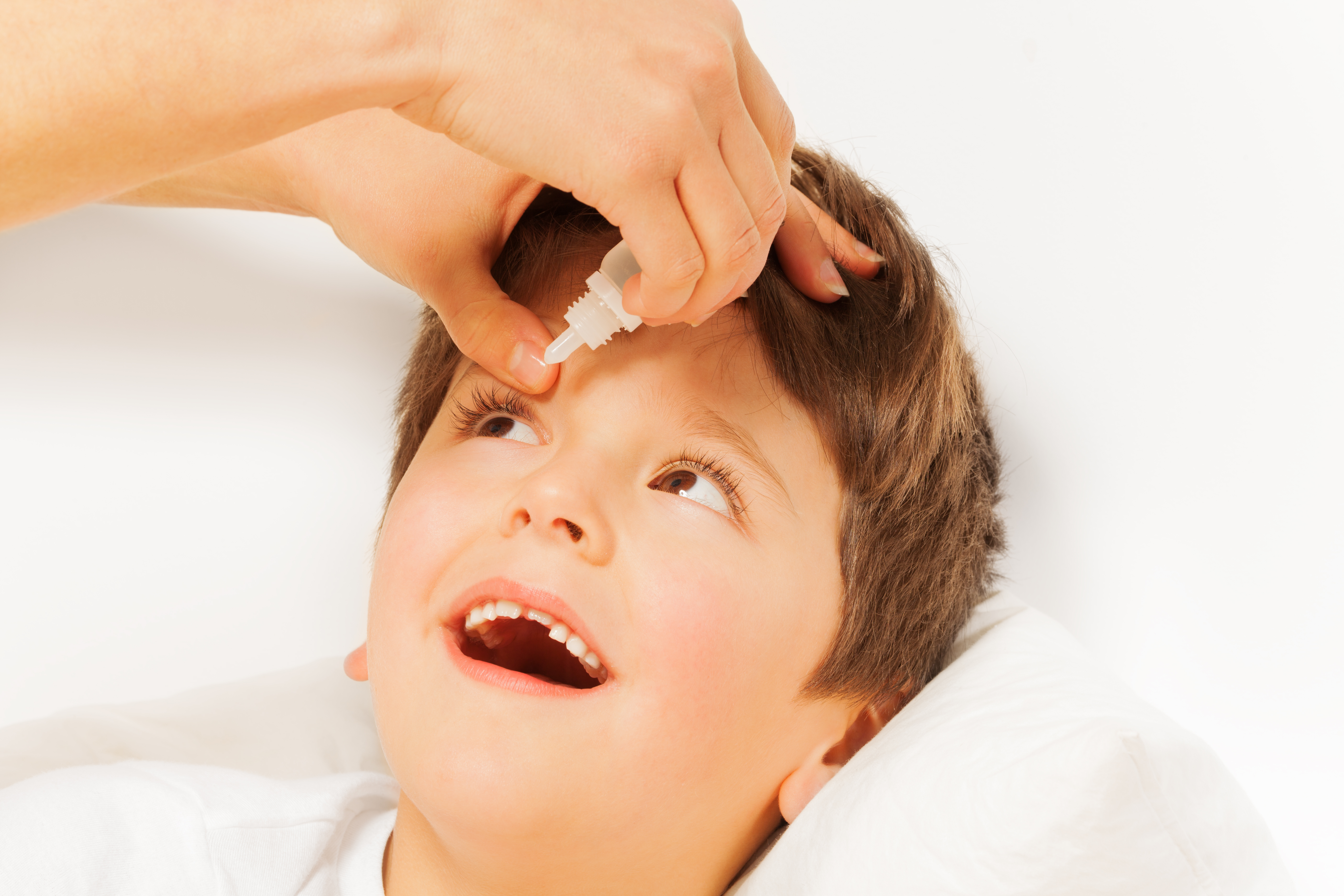 Close-up of kid getting eye drops
