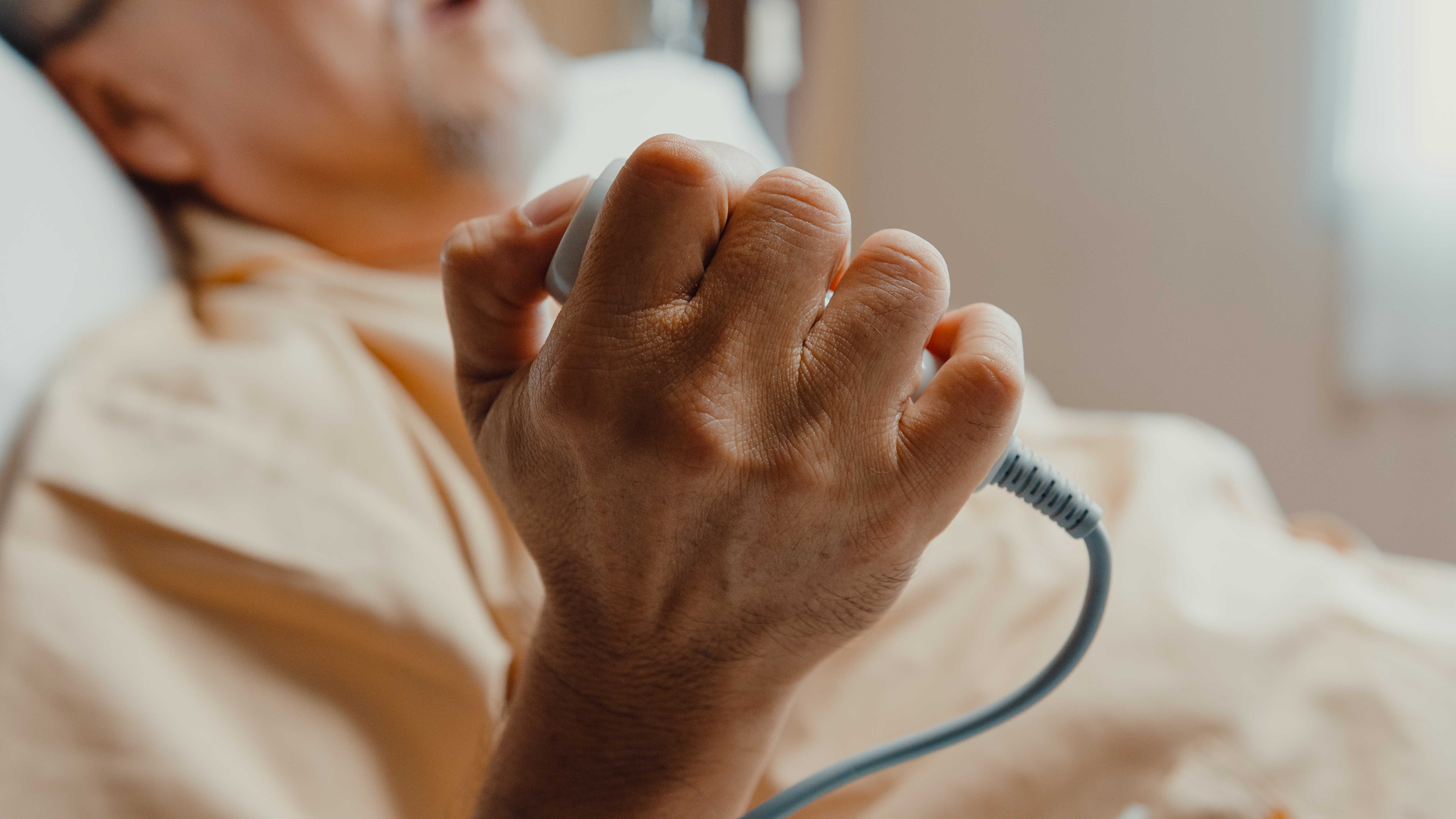 hand gripping call button