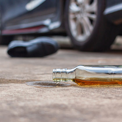 Liquor bottle at car accident scene