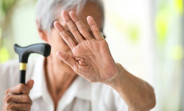 Elder raising hand in defense