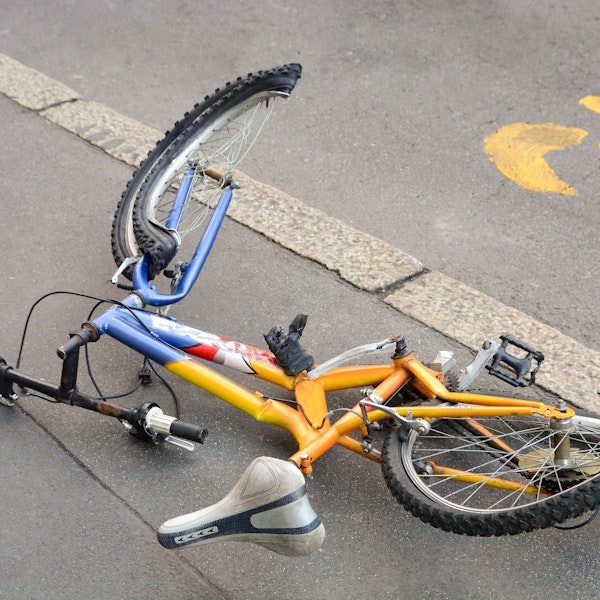 Damaged bicycle on the side of the road