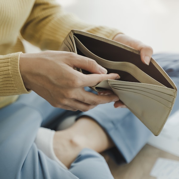 person looking in their empty wallet