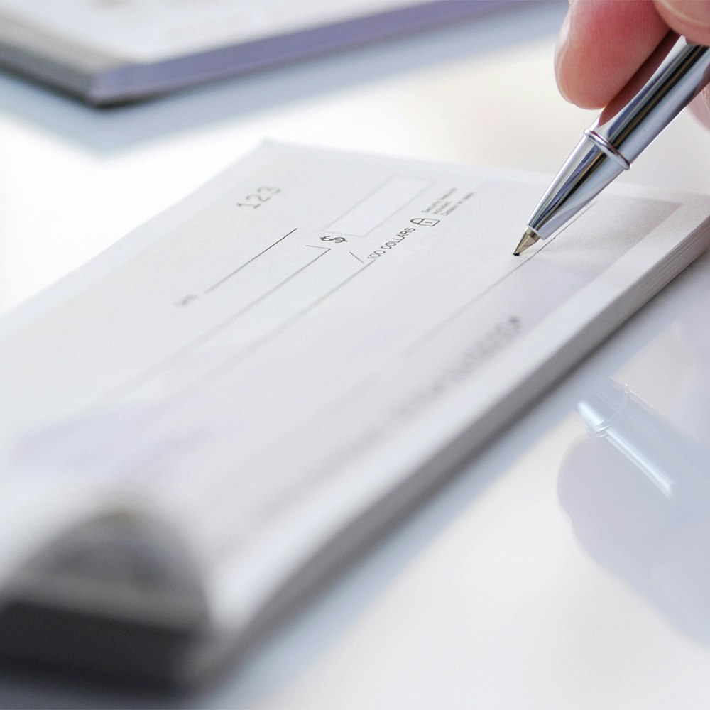 a hand writing a check