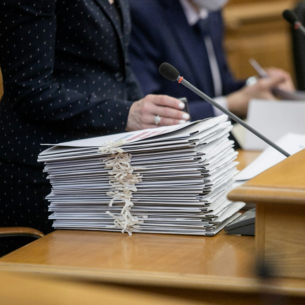 a stack of documents in a meeting