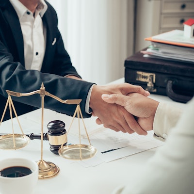 a handshake between an attorney and client
