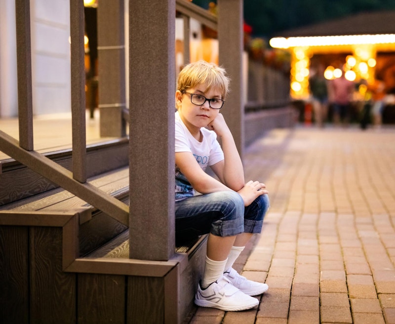 Sad-looking young boy who has suffered sexual abuse