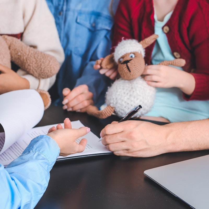 Agency worker meeting with foster parents and children