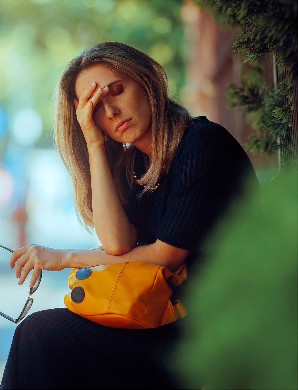 woman holding hand to brow, exasperated