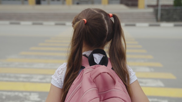 School girl about to cross the street
