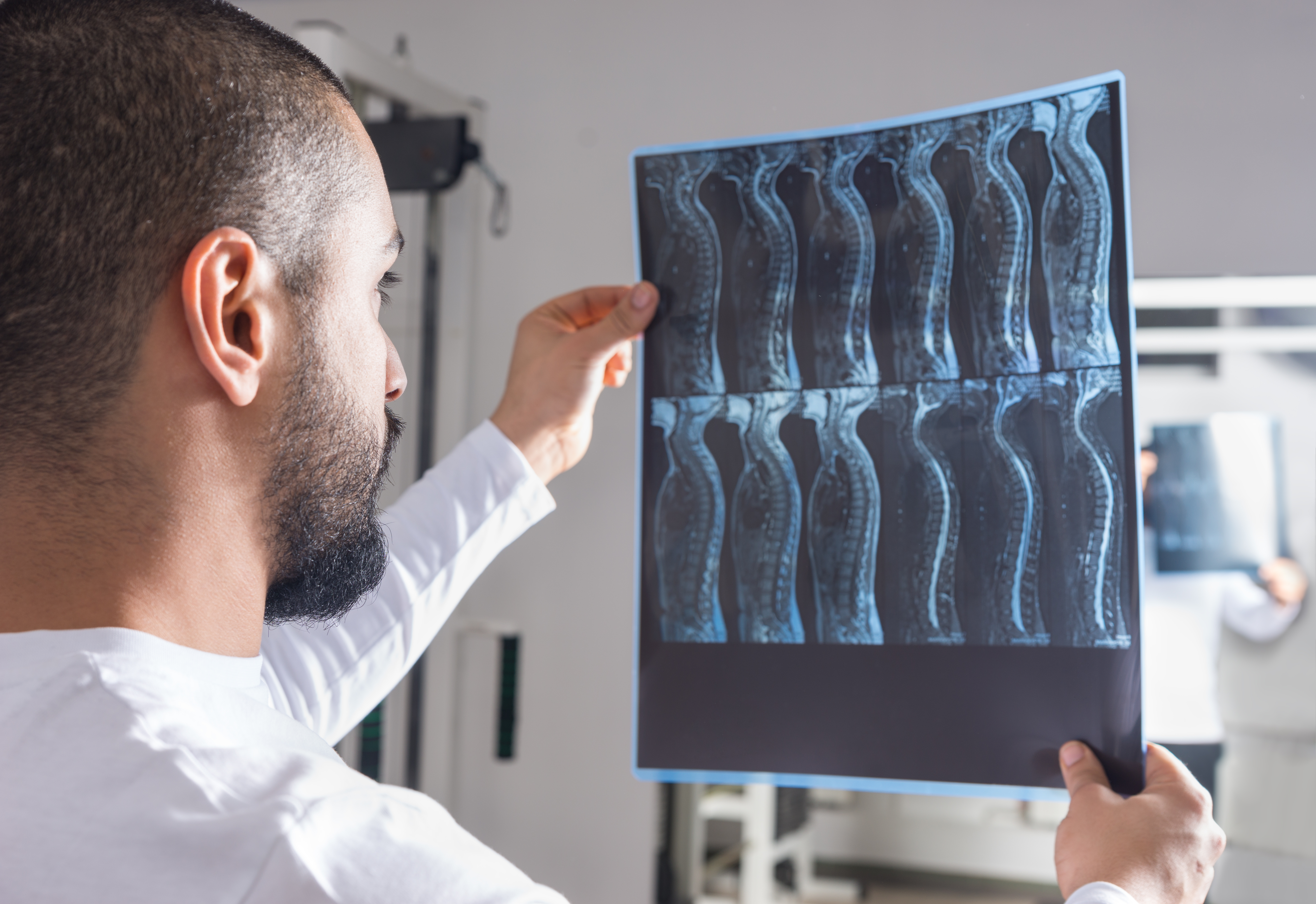 Doctor looking at spinal cord scans
