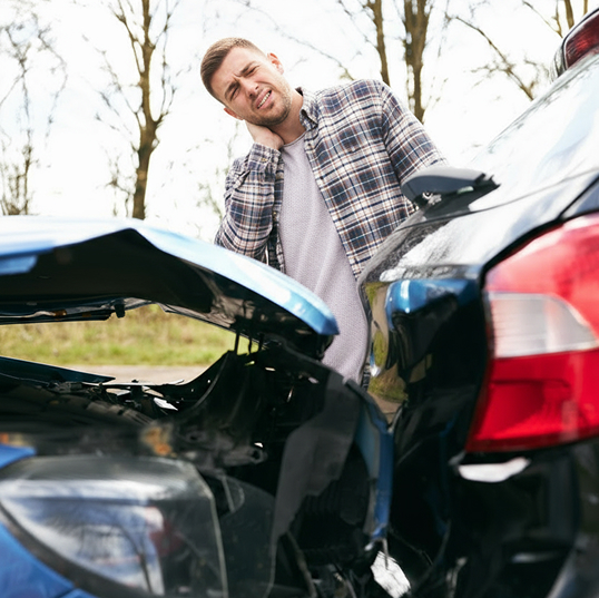 Man holding neck at accident scene